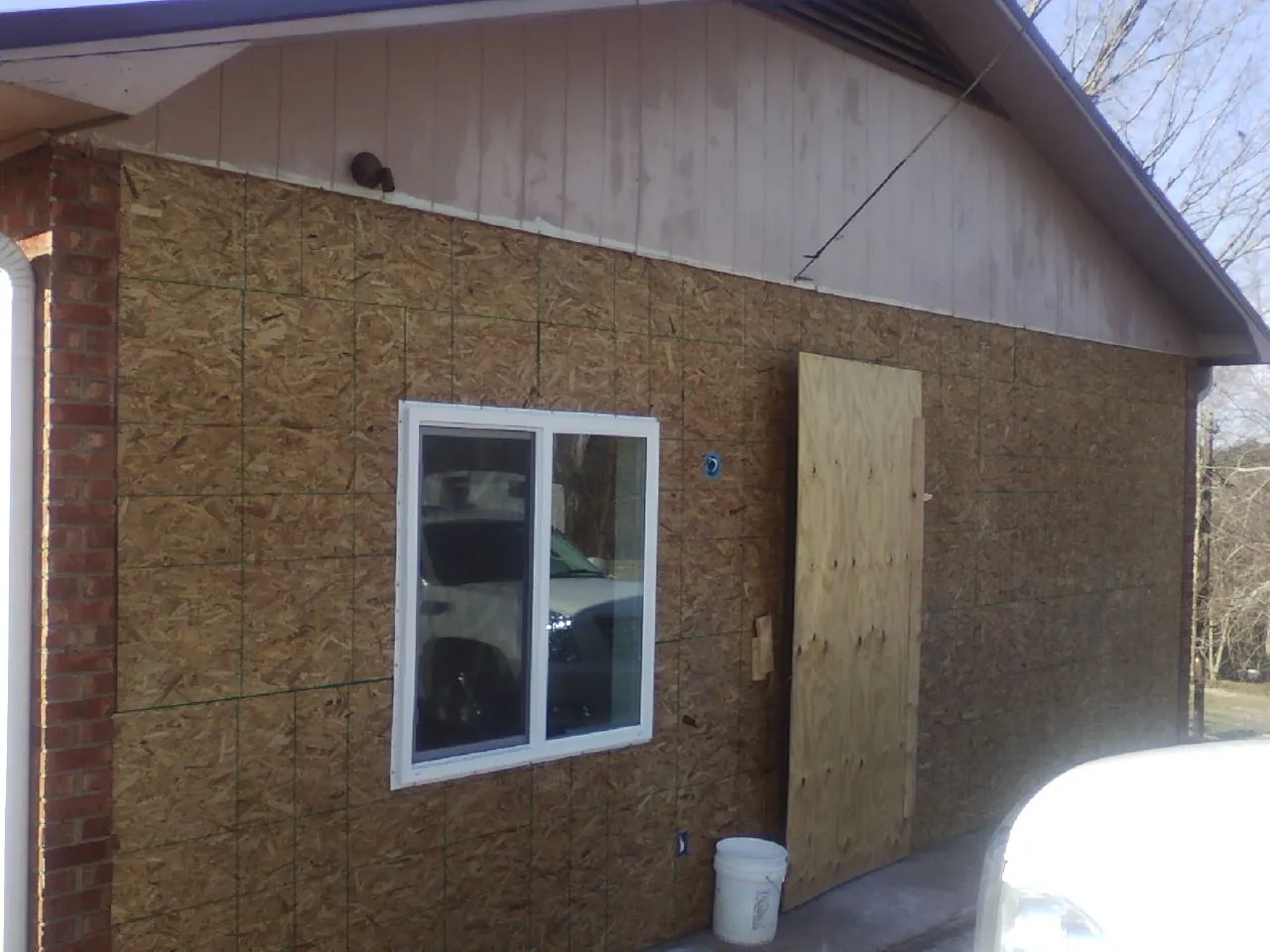 OSB sheathing on a garage addition wall before siding in Hanover Park