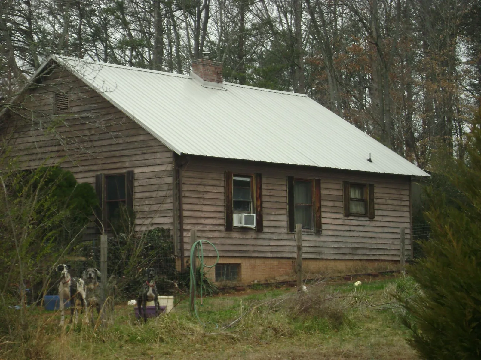 White metal roof on an old wood sided farmhouse, from a Metal Roof Installation job in Hanover Park